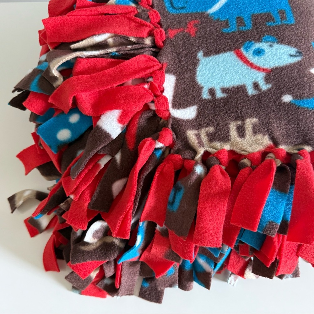 Soft, double-sided, anti-pilling fleece blanket. Hand-tied edges.